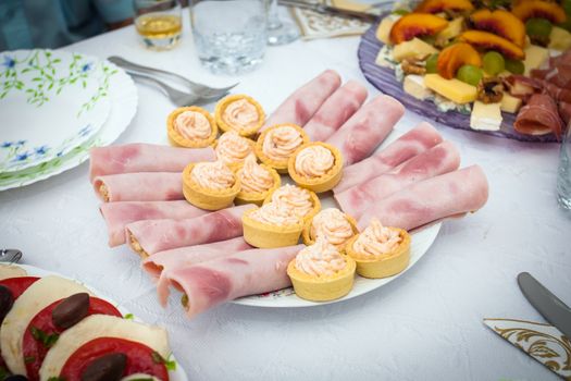 Cocktail food appetizer with ham rolls and and fish roe dip cream pastry