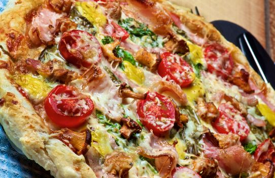 Delicious Mushrooms Pizza with Forest Chanterelles, Bacon, Tomatoes, Basil and Cheese closeup on Wooden background. Focus on Foreground