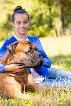 teen girl with the dog Bullmastiff outdoors