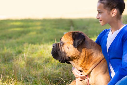 teen girl with the dog Bullmastiff outdoors