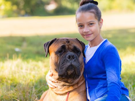 teen girl with the dog Bullmastiff outdoors