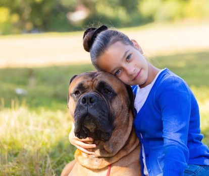 teen girl with the dog Bullmastiff outdoors