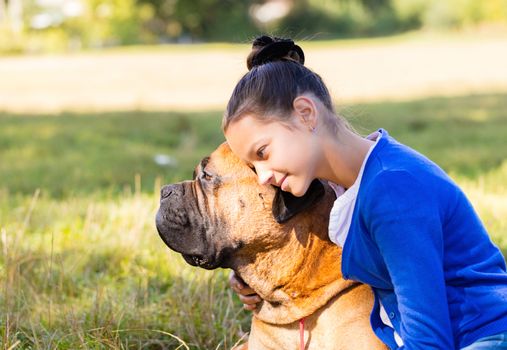 teen girl with the dog Bullmastiff outdoors