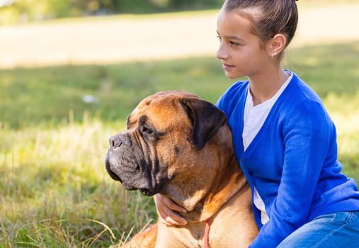 teen girl with the dog Bullmastiff outdoors