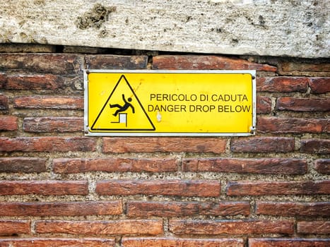 danger sign on a rough brick wall 