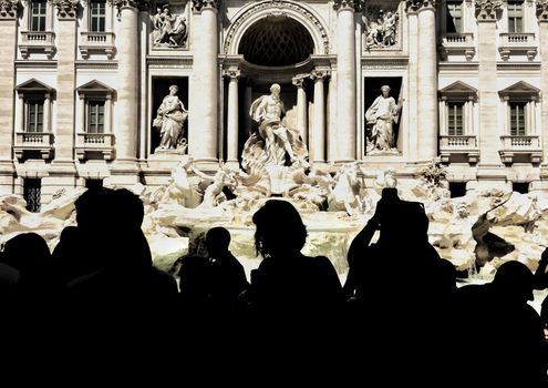 tourists silhouettes shooting the wonderful Trevi fountain in Rome