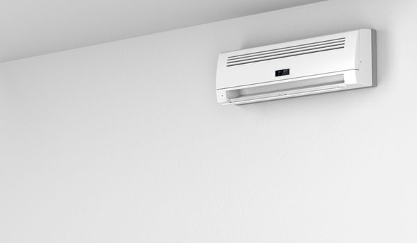 Modern air conditioner on white wall 