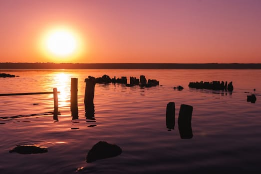 Colorful bright orange red summer sunset over lake