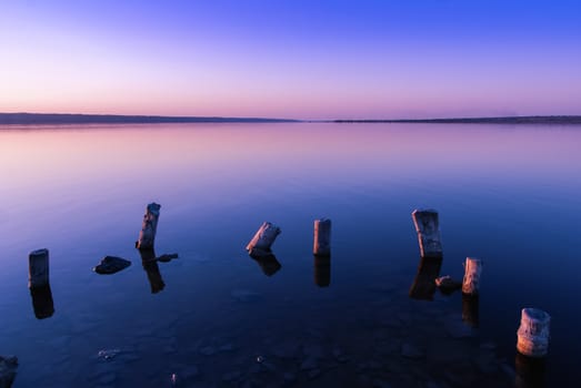 Colorful bright orange blue summer sunset over lake