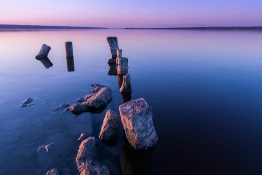 Colorful bright orange blue summer sunset over lake