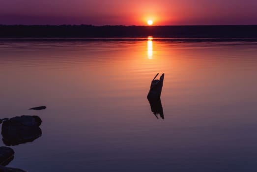 Colorful bright orange red summer sunset over lake