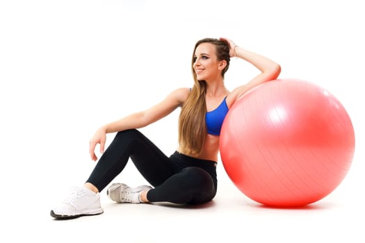 Concepts: healthy lifestyle, sport. Happy beautiful woman fitness trainer working out with fit ball isolated on white background