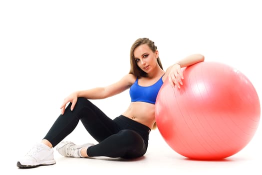 Concepts: healthy lifestyle, sport. Happy beautiful woman fitness trainer working out with fit ball isolated on white background