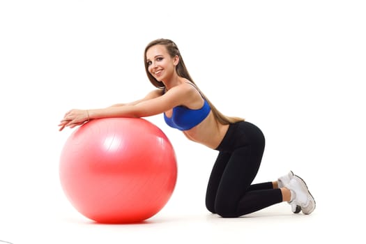 Concepts: healthy lifestyle, sport. Happy beautiful woman fitness trainer working out with fit ball isolated on white background