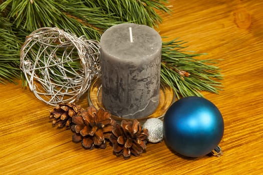 New Year 2017 composition with fir cones and grey candle on wooden background