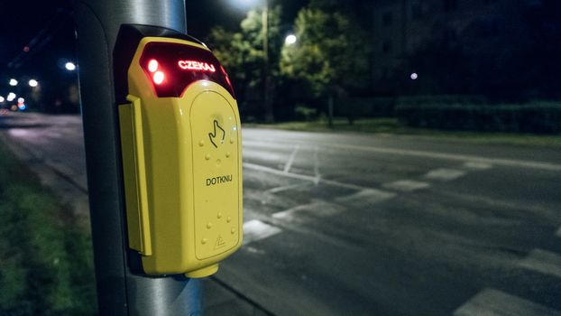 Button to Cross the Street in Crowded Area in the City