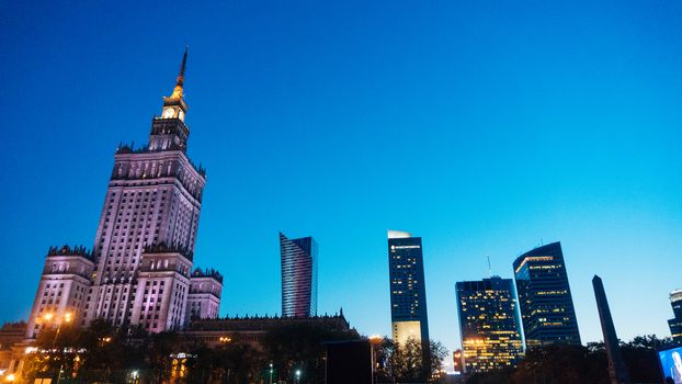 Warsaw, Poland. City center with Palace of Culture and Science, a landmark and symbol of Stalinism and communism, and modern sky scrapers.