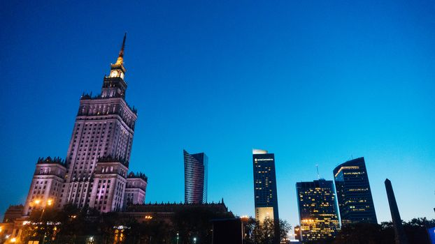 Warsaw, Poland. City center with Palace of Culture and Science, a landmark and symbol of Stalinism and communism, and modern sky scrapers.