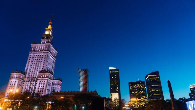 Warsaw, Poland. City center with Palace of Culture and Science, a landmark and symbol of Stalinism and communism, and modern sky scrapers.