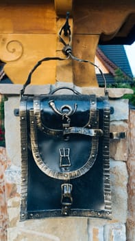 An perspective view of an old school retro tin mailbox bulging on an isolated background