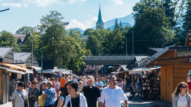 ZAKOPANE, POLAND - SEPTEMBER 2, 2016: Market Stalls with Tourists Honey and Pickles in Zakopane.