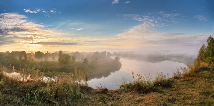 Foggy river in the autumn morning. Panorama