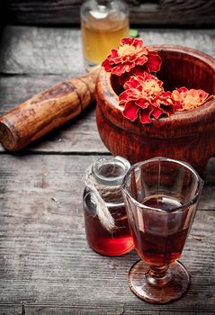 Mortar with healing flowers, plant marigolds and pestle