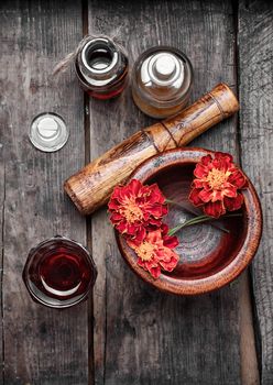 Mortar with healing flowers, plant marigolds and pestle