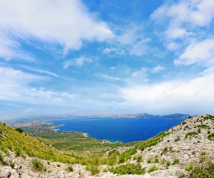 Bay / coast panorama with cloudy sky - mountains in front - north of majorca, spain