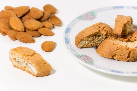 Cantuccini, original Italian almond cookies on a plate on white background