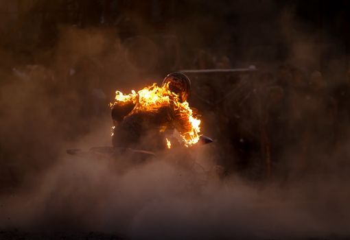 stuntman riding on a quad bike and burns