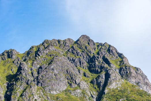 Colorful summer landscape with sharp mountain peaks in Norway.