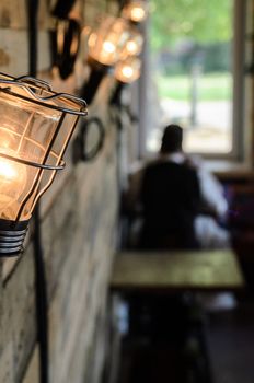 interior wooden cafe with lamps on the wall