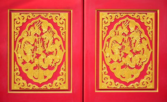 Golden dragon on the red door of Chinese temple in Thailand