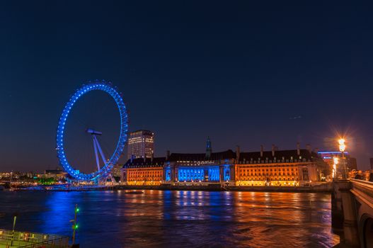 LONDON, UNITED KINGDOM - May 10: Night view of the South Bank of the River Thames including the world famous landmark, London Eye on May 10, 2011 in London.