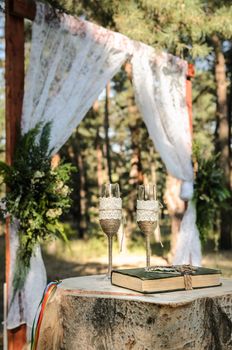 wedding ceremony in the woods among the trees on the green track