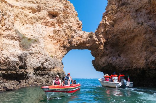 Lagos, Portugal - September 1, 2014: Tourists visit sea the cave in the famous Portuguese rock formations.