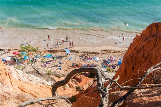 ALBUFEIRA, PORTUGAL - AUGUST 29, 2014: Crowded Falesia Beach seen from the cliff. This beach is a part of famous tourist region Algarve.