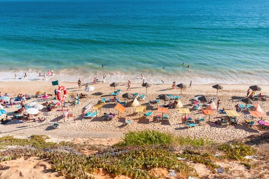 ALBUFEIRA, PORTUGAL - AUGUST 29, 2014: Crowded Falesia Beach seen from the cliff. This beach is a part of famous tourist region Algarve.