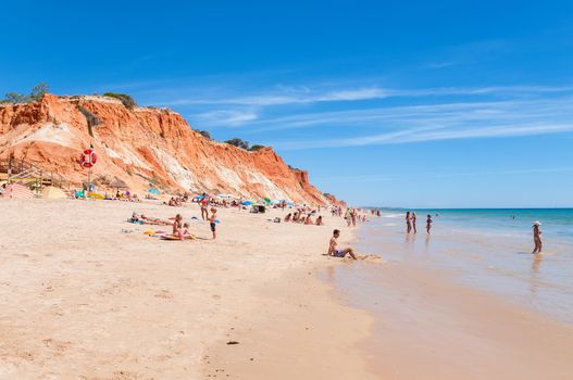 Albufeira, Portugal - August 30, 2014: Crowded Falesia Beach seen from the cliff. This beach is a part of famous tourist region Algarve.