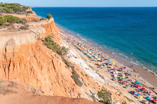 Albufeira, Portugal - August 29, 2014: Crowded Falesia Beach seen from the cliff. This beach is a part of famous tourist region Algarve.