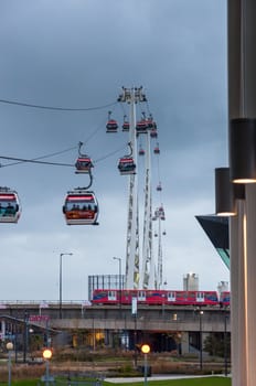 London, United Kingdom - November 8, 2014:  Gondolas of the Emirates Air Line cable car in London on a rainy day. Thames cable car is a ten minute gondola lift link across the River Thames.