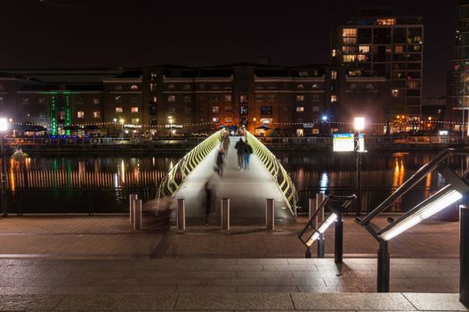 London, United Kingdom - November 10, 2014: Illuminated foot bridge in over North Dock in Canary Wharf by night