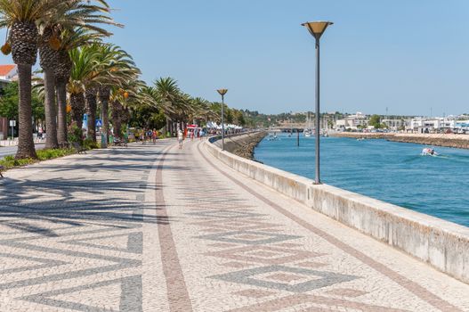 LAGOS, PORTUGAL - SEPTEMBER 1: Palm Trees along the beautifully paved promenade on 1 September, 2014 in Lagos. Lagos is one of the most visited cities in the Algarve and Portugal.