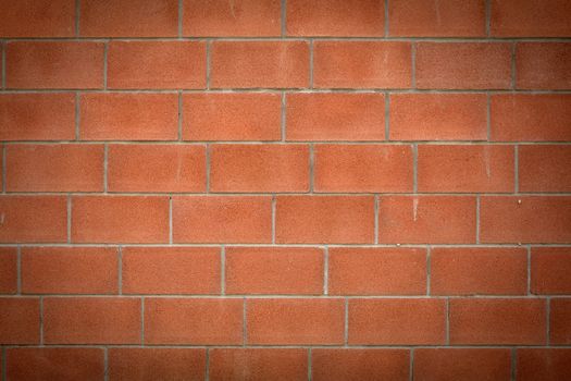 Abstract brick red wall. Vignetting at the edges
