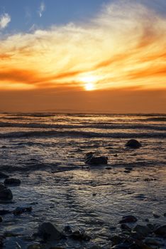 reflections at rocky beal beach near ballybunion on the wild atlantic way ireland with a beautiful yellow sunset