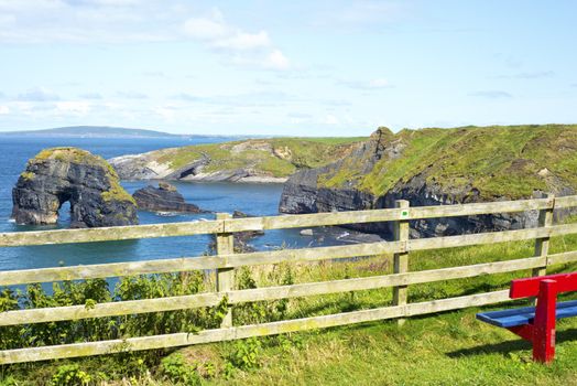 seat with view of virgin rock near cliffs on the wild atlantic way in ballybunion county kerry ireland