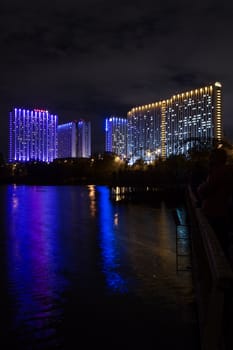 Moscow, Russia - September 10, 2016: Night view illuminated Tourist Hotel Izmailovo is reflected in the water of the famous Izmailovo pond
