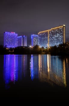 Moscow, Russia - September 10, 2016: Night view illuminated Tourist Hotel Izmailovo is reflected in the water of the famous Izmailovo pond