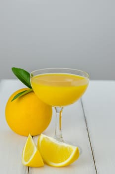 Orange juice and slices on wood